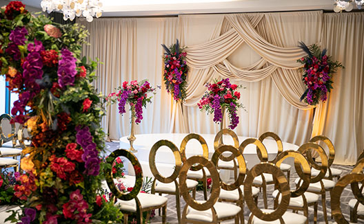 Room set up for wedding with colorful flowers and seating